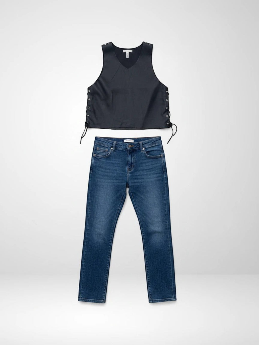 Top negro de piel Pampa Boho con cordones laterales, tachuelas y estrella en la espalda, combinado con vaqueros azules.